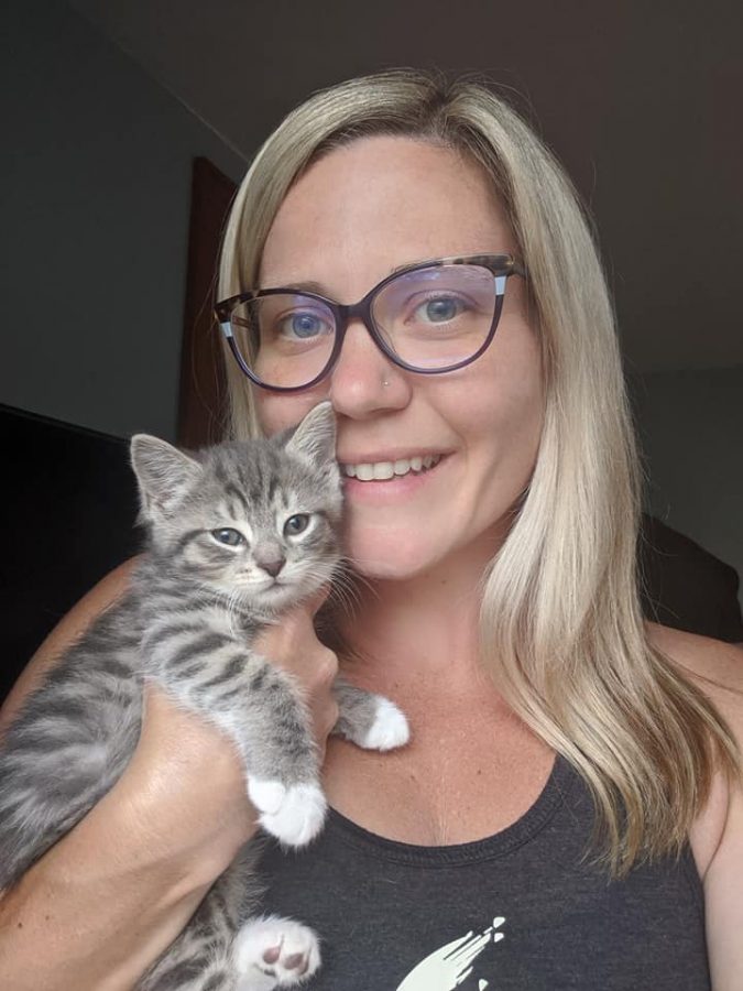 Intervention specialist Louise Milton with one of her fostered kittens. 