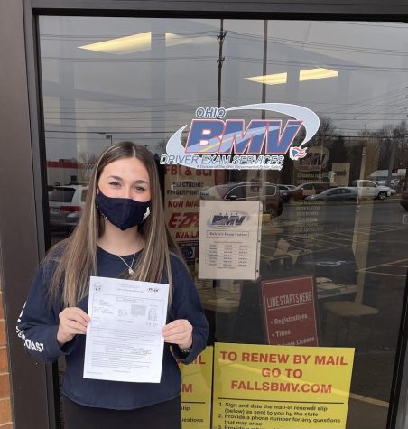 Sophomore Karly Reger holds her temporary permit in front of the BMV January 12. She plans to take her drivers test in July. 