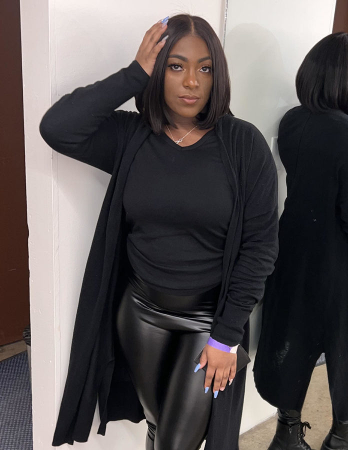 Junior Ryenne Hubbard captures a moment backstage before performing at the "The House of Glo" fashion show during All-Star Weekend in Cleveland.