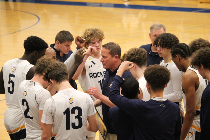 Varsity coach Nick Marcini leads the team in a huddle during a timeout. This was the 13th year Marcini, a former Rocket basketball and football star himself, served as head coach of the Varsity team.