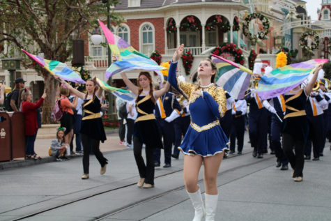 Leading the Marching Rockets down Main Street, Disney are junior auxiliary members Jaime Graves, Colleen Jordan and Kim Biada.